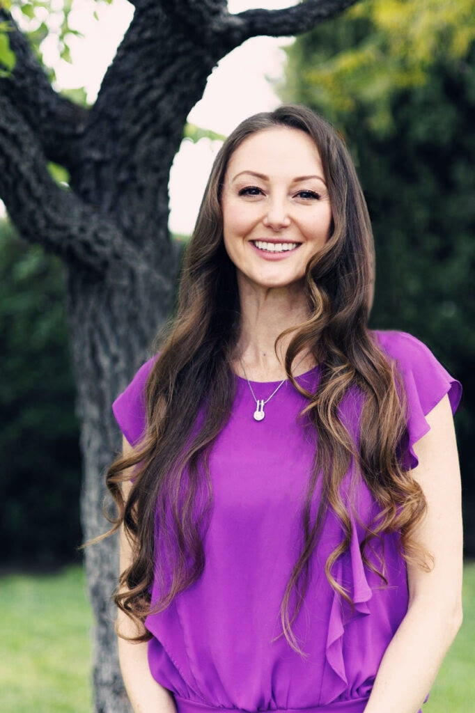 Natalie Tan, Orange County Realtor, smiling outdoors.